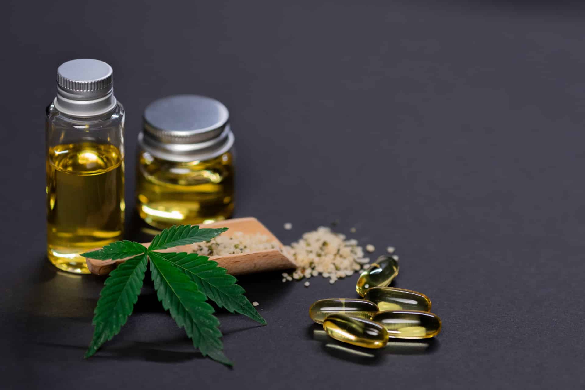 CBD bien-être : flacons d'huile de CBD sur une table avec des éléments naturels autour